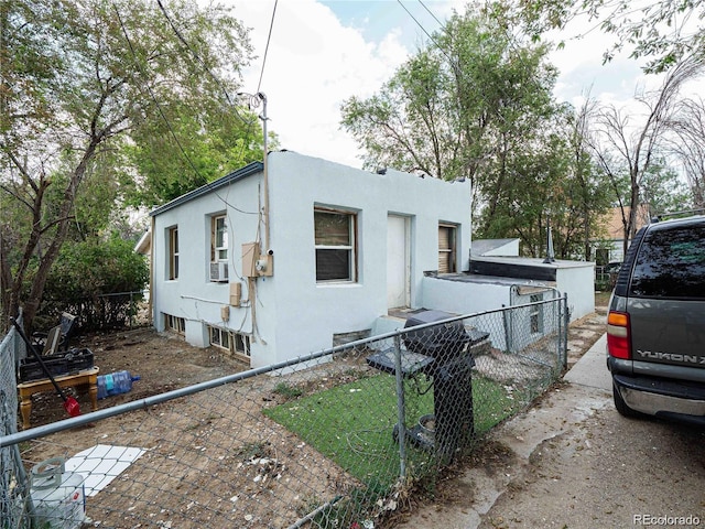 view of property exterior with fence and stucco siding