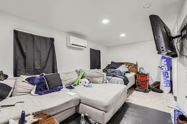 bedroom with recessed lighting, wood finished floors, and a wall mounted AC