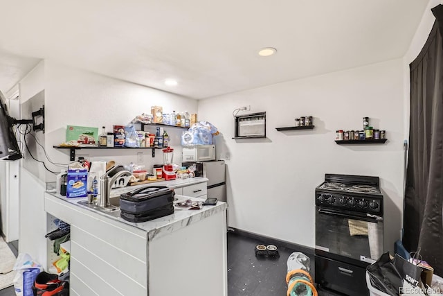 kitchen with baseboards, gas stove, white microwave, light countertops, and recessed lighting