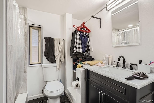 bathroom featuring curtained shower, vanity, toilet, and tile patterned floors