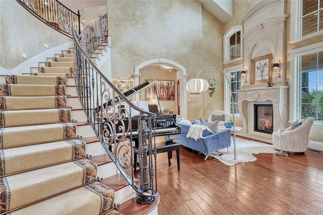 living room featuring a high ceiling and hardwood / wood-style flooring