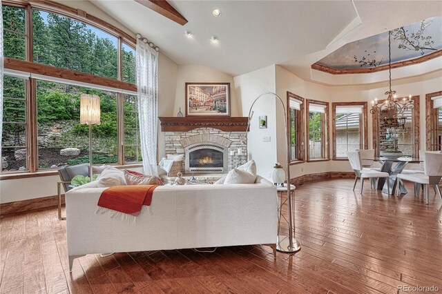 living room with a wealth of natural light, a fireplace, and hardwood / wood-style flooring