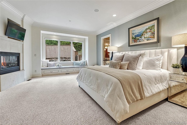 carpeted bedroom featuring a tile fireplace and ornamental molding