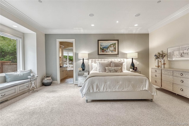 bedroom with light colored carpet, ensuite bath, and multiple windows