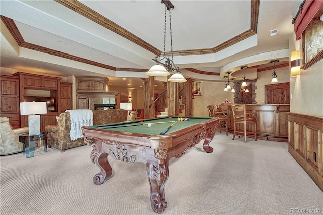 game room featuring a large fireplace, a raised ceiling, billiards, bar area, and light carpet