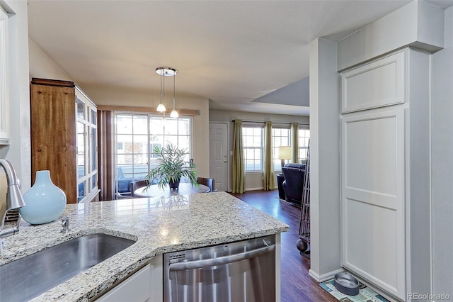 kitchen featuring dishwasher, white cabinetry, dark hardwood / wood-style floors, light stone countertops, and decorative light fixtures