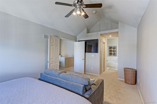 bedroom featuring ceiling fan, ensuite bath, lofted ceiling, and light carpet