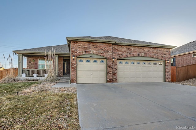 view of front of home featuring a porch and a garage