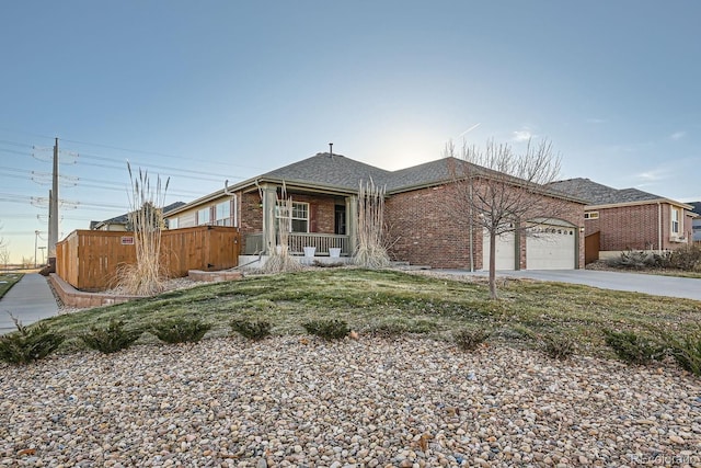 ranch-style home with covered porch and a garage