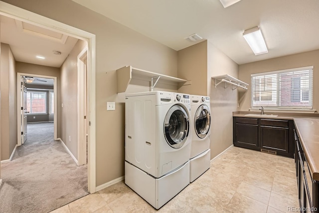 laundry room featuring light colored carpet, independent washer and dryer, and sink