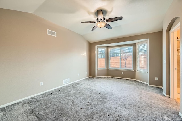 spare room featuring ceiling fan, carpet floors, and lofted ceiling