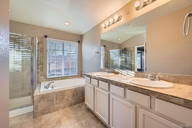 bathroom with vanity, independent shower and bath, and vaulted ceiling