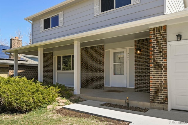 9562 W Capri Dr, Littleton, CO 80123 - doorway to property with brick siding and covered porch