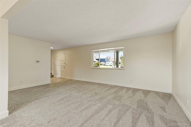 9562 W Capri Dr, Littleton, CO 80123 - unfurnished room featuring light carpet, baseboards, and a textured ceiling