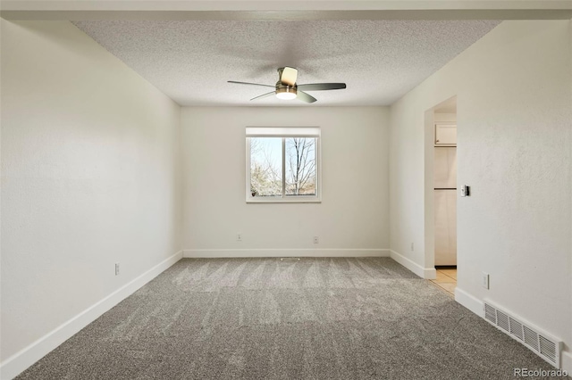 9562 W Capri Dr, Littleton, CO 80123 - unfurnished room featuring visible vents, ceiling fan, light colored carpet, and a textured ceiling