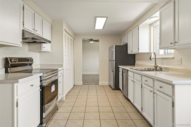 9562 W Capri Dr, Littleton, CO 80123 - kitchen with light tile patterned floors, appliances with stainless steel finishes, under cabinet range hood, light countertops, and a sink