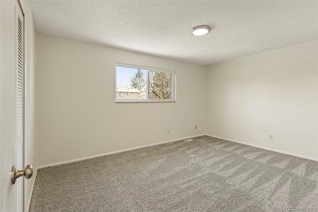 9562 W Capri Dr, Littleton, CO 80123 - carpeted empty room with baseboards and a textured ceiling