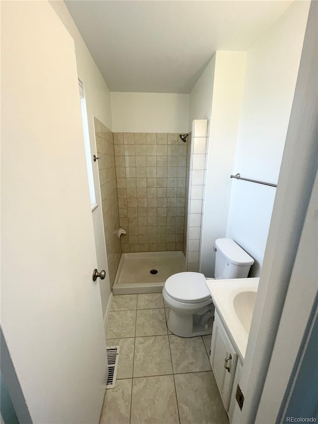 9562 W Capri Dr, Littleton, CO 80123 - bathroom featuring vanity, tile patterned flooring, toilet, visible vents, and a tile shower