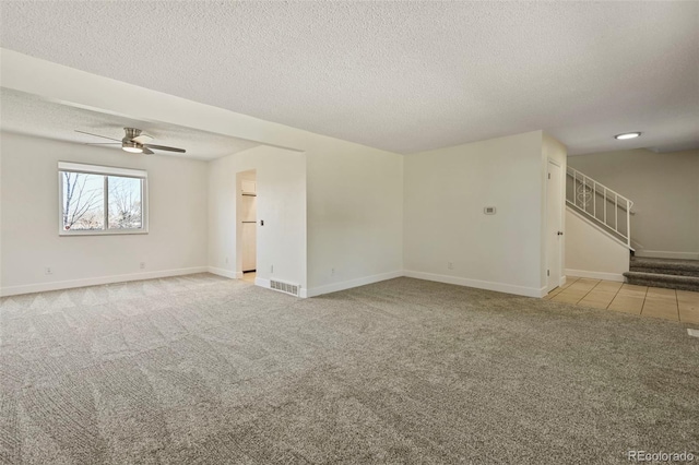 9562 W Capri Dr, Littleton, CO 80123 - unfurnished room featuring visible vents, ceiling fan, carpet, a textured ceiling, and stairway