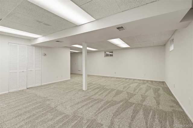9562 W Capri Dr, Littleton, CO 80123 - finished below grade area featuring visible vents, baseboards, a paneled ceiling, and carpet
