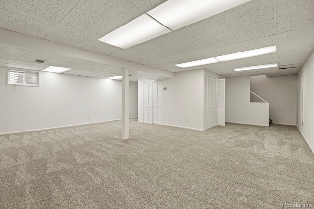 9562 W Capri Dr, Littleton, CO 80123 - finished basement featuring a drop ceiling, visible vents, stairway, carpet flooring, and baseboards