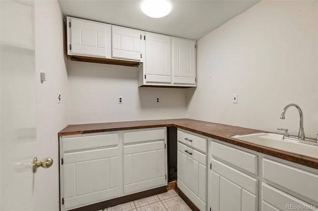 9562 W Capri Dr, Littleton, CO 80123 - kitchen with a sink, butcher block countertops, and white cabinetry