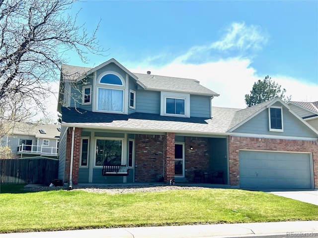 view of front facade with a front yard, a garage, and a porch