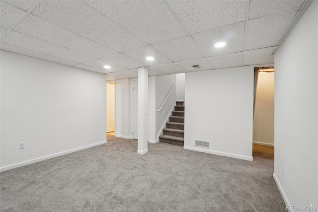 finished below grade area featuring stairs, recessed lighting, visible vents, and baseboards