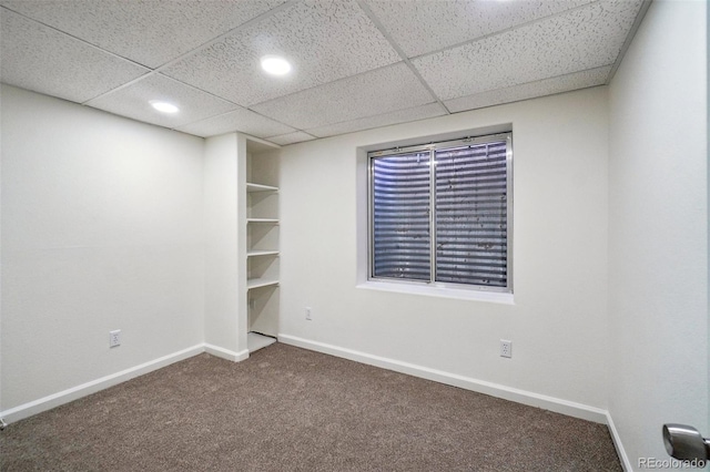 unfurnished room featuring carpet, baseboards, a drop ceiling, and recessed lighting