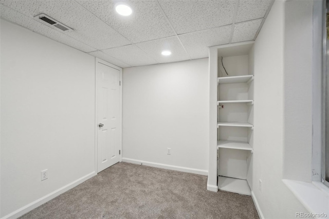 finished below grade area featuring baseboards, visible vents, a drop ceiling, carpet flooring, and recessed lighting