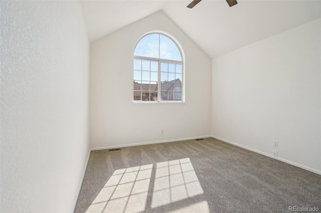 unfurnished room featuring baseboards, visible vents, a ceiling fan, lofted ceiling, and carpet