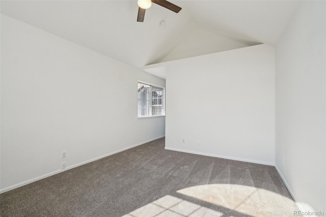 carpeted empty room with lofted ceiling, ceiling fan, and baseboards