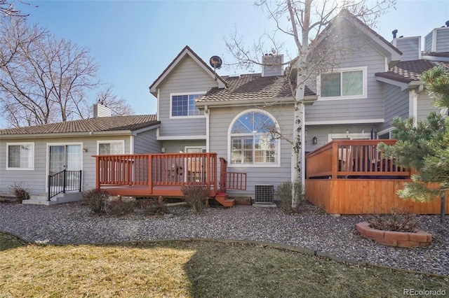 rear view of house featuring central air condition unit, a chimney, and a wooden deck