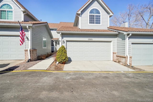 traditional-style house featuring concrete driveway
