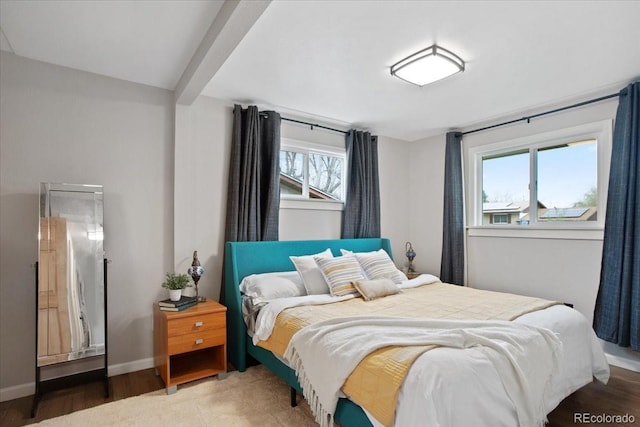 bedroom with baseboards and wood finished floors