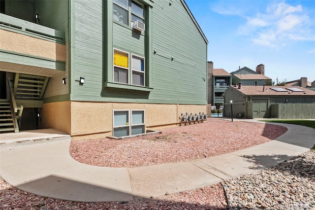 128 W Rockrimmon Blvd Unit 105, Colorado Springs, CO 80919 - view of side of home with stairs, a residential view, and stucco siding