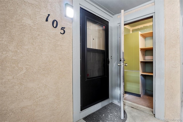 128 W Rockrimmon Blvd Unit 105, Colorado Springs, CO 80919 - doorway to property with stucco siding