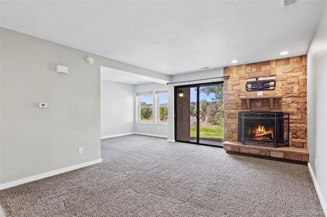 128 W Rockrimmon Blvd Unit 105, Colorado Springs, CO 80919 - unfurnished living room featuring carpet, a fireplace, and recessed lighting