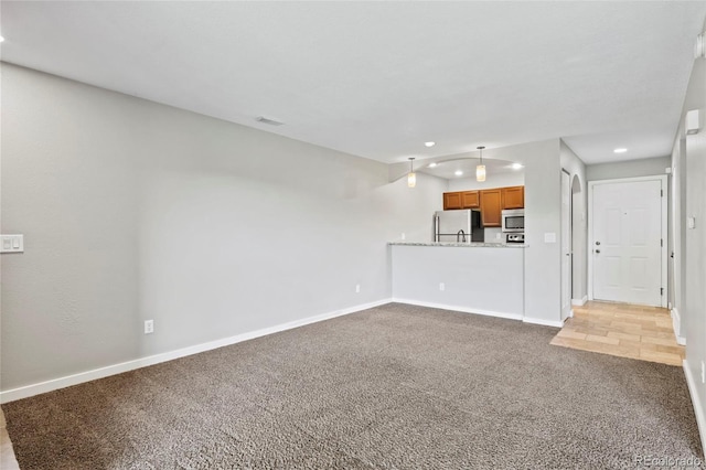 128 W Rockrimmon Blvd Unit 105, Colorado Springs, CO 80919 - unfurnished living room with light colored carpet and recessed lighting