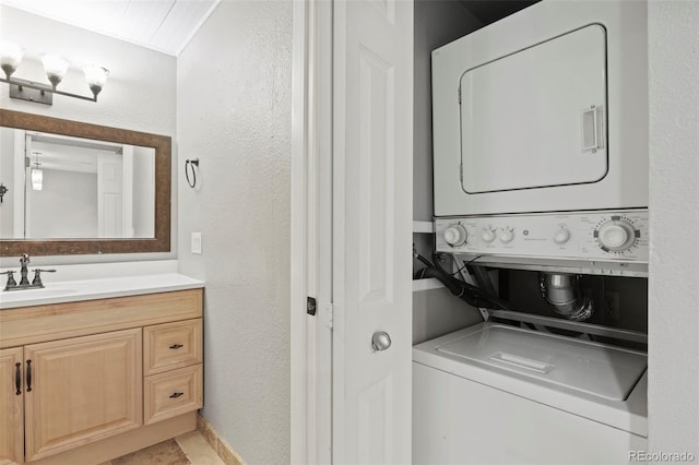 128 W Rockrimmon Blvd Unit 105, Colorado Springs, CO 80919 - laundry area with stacked washer and clothes dryer and a textured wall