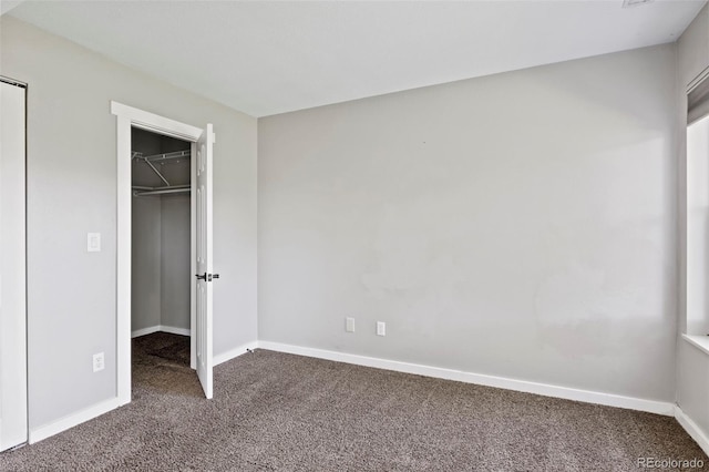 128 W Rockrimmon Blvd Unit 105, Colorado Springs, CO 80919 - unfurnished bedroom featuring carpet and a spacious closet