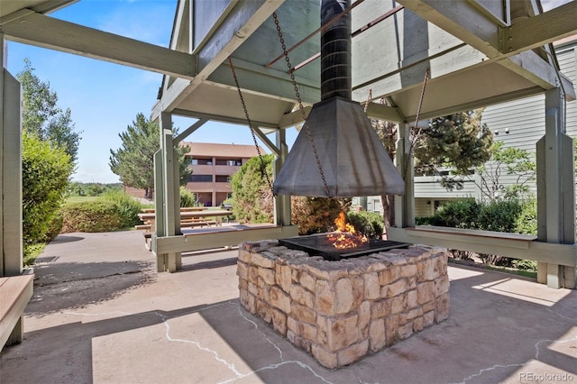 128 W Rockrimmon Blvd Unit 105, Colorado Springs, CO 80919 - view of patio / terrace with an outdoor fire pit