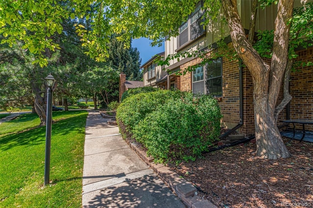 8039 E Phillips Cir, Centennial, CO 80112 - view of side of home featuring brick siding and a yard