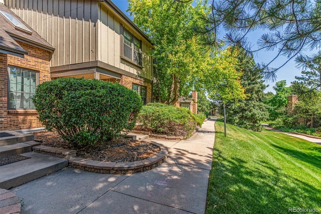 8039 E Phillips Cir, Centennial, CO 80112 - view of home's exterior with a yard, brick siding, and board and batten siding