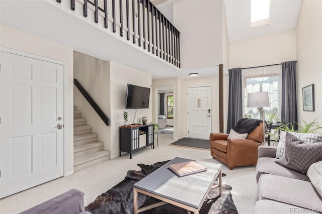 8039 E Phillips Cir, Centennial, CO 80112 - carpeted living area featuring a towering ceiling and stairway