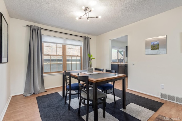 8039 E Phillips Cir, Centennial, CO 80112 - dining area featuring a textured ceiling, wood finished floors, and a chandelier