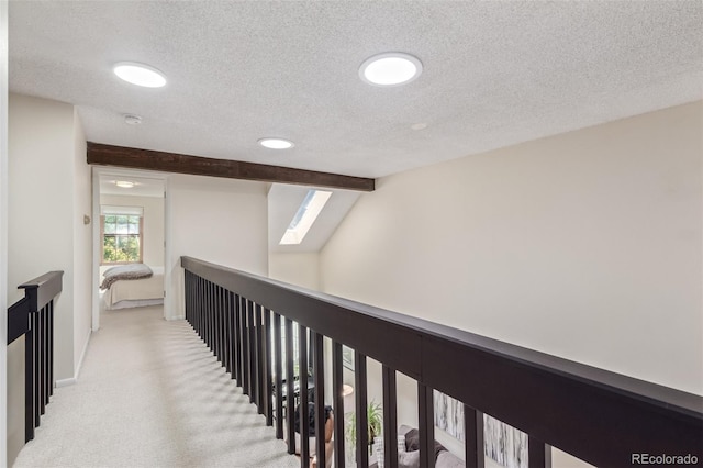 8039 E Phillips Cir, Centennial, CO 80112 - hallway featuring a skylight, a textured ceiling, carpet floors, an upstairs landing, and recessed lighting