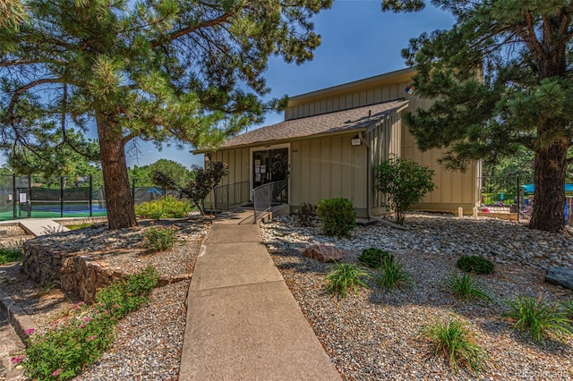 8039 E Phillips Cir, Centennial, CO 80112 - view of front facade featuring a tennis court, a shingled roof, and board and batten siding