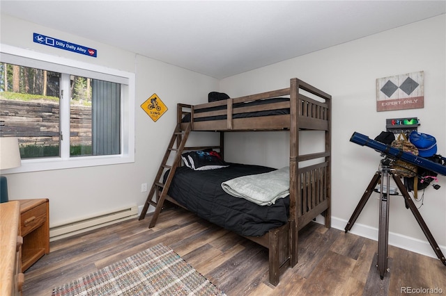 141 Forest Trl # 16, Winter Park, CO 80482 - bedroom with a baseboard heating unit and wood finished floors