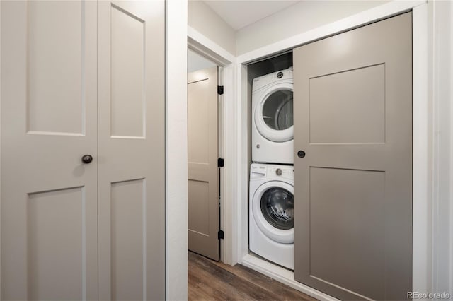 141 Forest Trl # 16, Winter Park, CO 80482 - washroom featuring stacked washing machine and dryer and dark wood-style flooring